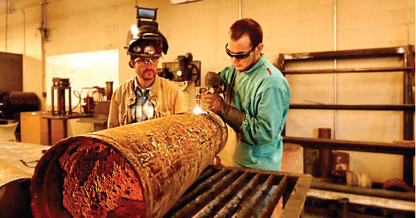 two students learning the welding trade at a school for welders