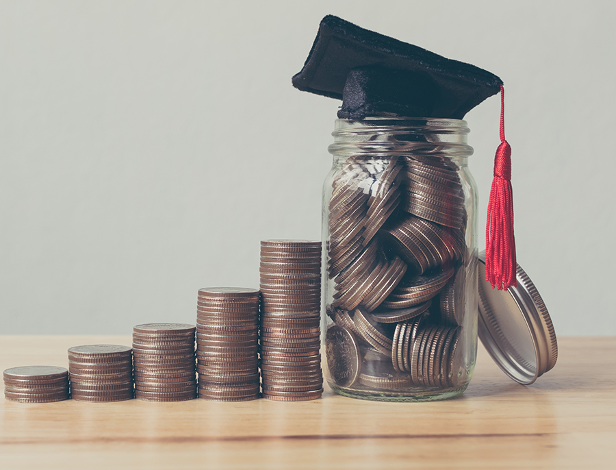 coins in jar with graduation cap