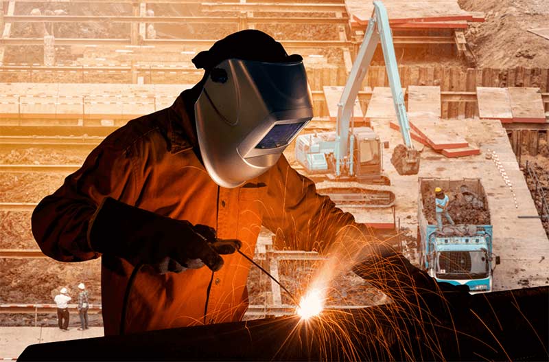Highly-skilled and trained welders are needed all over Texas to fill structural welding jobs in Texas. | Conceptual photo of structural welder welding a beam on top of construction site.