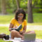 A female studying for a summer semester class in college while at the park.